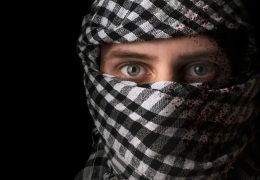 terrorist in blood, in a black mask on a black background